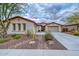 Charming single-story home with desert landscaping, two-car garage and beautiful desert plants at 30550 N 125Th Dr, Peoria, AZ 85383