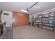 Spacious garage equipped with storage cabinets and epoxy flooring at 30550 N 125Th Dr, Peoria, AZ 85383