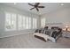 Relaxing main bedroom features a ceiling fan, plantation shutters, and neutral tones at 30550 N 125Th Dr, Peoria, AZ 85383