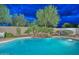 Relax poolside in this stunning pool complete with a rock waterfall and lush landscaping at 30550 N 125Th Dr, Peoria, AZ 85383