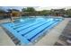 An inviting pool with blue-lined lanes, surrounded by lounge chairs and shaded seating areas at 30550 N 125Th Dr, Peoria, AZ 85383