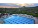 Aerial view of a beautiful pool with lounge chairs and umbrellas, against a scenic mountain backdrop at 30550 N 125Th Dr, Peoria, AZ 85383