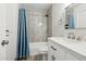 Well-lit bathroom featuring a stylish vanity with a large mirror and tiled shower at 3224 E Sweetwater Ave, Phoenix, AZ 85032