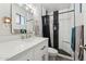 Modern bathroom featuring a sleek vanity, mirror, and stylish tiled shower with storage niche at 3224 E Sweetwater Ave, Phoenix, AZ 85032
