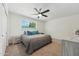 Cozy bedroom with ceiling fan, carpet flooring, and a large window with natural light at 3224 E Sweetwater Ave, Phoenix, AZ 85032