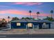 Charming single-story home with solar panels and desert landscaping under a colorful sky at 3224 E Sweetwater Ave, Phoenix, AZ 85032
