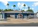 Charming blue home with an open garage, basketball hoop, desert landscaping, and solar panels at 3224 E Sweetwater Ave, Phoenix, AZ 85032