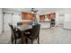 Open kitchen and dining area with stainless steel appliances, cabinets, and tile flooring at 3224 E Sweetwater Ave, Phoenix, AZ 85032