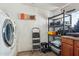 Bright laundry room featuring modern washer, storage shelves, and ample workspace at 3224 E Sweetwater Ave, Phoenix, AZ 85032