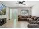 Comfortable living room features tile floors, a ceiling fan, and a large sectional sofa at 3224 E Sweetwater Ave, Phoenix, AZ 85032