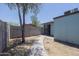 Backyard featuring a shade tree, a block fence, concrete path and access door at 3646 N 67Th Ave # 12, Phoenix, AZ 85033