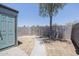 Backyard with concrete path to a metal gate surrounded by a block wall and a shade tree at 3646 N 67Th Ave # 12, Phoenix, AZ 85033