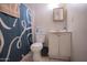 Cozy bathroom features a toilet, vanity with mirror, and shower with curtain at 3646 N 67Th Ave # 12, Phoenix, AZ 85033