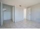 An empty bedroom provides a blank canvas for your design aspirations, featuring tile floors and a spacious closet at 3646 N 67Th Ave # 12, Phoenix, AZ 85033
