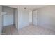 This bedroom features neutral walls, tile floors, a closet and a door leading to another room at 3646 N 67Th Ave # 12, Phoenix, AZ 85033