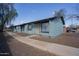 Charming blue apartment building with decorative bars, rock landscaping, and a well-maintained walkway at 3646 N 67Th Ave # 12, Phoenix, AZ 85033