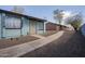 Blue apartment with decorative bars, rock landscaping, concrete walkway, and secure doorway at 3646 N 67Th Ave # 12, Phoenix, AZ 85033