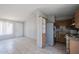Functional kitchen with tile flooring, appliances, a window, and open access to the living area at 3646 N 67Th Ave # 12, Phoenix, AZ 85033