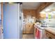 Functional kitchen featuring wooden cabinets, white appliances, and laminate countertops at 3646 N 67Th Ave # 12, Phoenix, AZ 85033