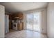 Practical eat-in kitchen with tile floors, appliances, wooden cabinetry, and a sliding door at 3646 N 67Th Ave # 12, Phoenix, AZ 85033