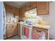 Functional kitchen featuring wooden cabinets, white appliances, laminate countertops, and a sink at 3646 N 67Th Ave # 12, Phoenix, AZ 85033