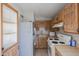 Close-up view of a kitchen featuring tile floor, wood cabinets, appliances, and countertop at 3646 N 67Th Ave # 12, Phoenix, AZ 85033