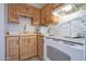 Compact kitchen with wooden cabinetry and basic appliances at 3646 N 67Th Ave # 12, Phoenix, AZ 85033