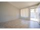 Bright living room with tile flooring, neutral walls, and a view of the outdoors through a window at 3646 N 67Th Ave # 12, Phoenix, AZ 85033
