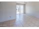 Open living space with sliding glass doors leading to a fenced patio, tile floor, ceiling fan at 3646 N 67Th Ave # 12, Phoenix, AZ 85033