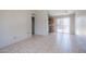 Spacious living room with tiled flooring, a sliding glass door, and access to the kitchen at 3646 N 67Th Ave # 12, Phoenix, AZ 85033