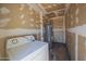 This utility room contains a washer, dryer, and water heater with unfinished walls at 3646 N 67Th Ave # 12, Phoenix, AZ 85033