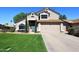 Charming two-story home with a well-manicured lawn, two-car garage, and a beautifully designed front door at 4338 E Towne Ln, Gilbert, AZ 85234