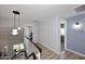 Bright hallway featuring wood floors, modern light fixtures, and access to multiple rooms at 4338 E Towne Ln, Gilbert, AZ 85234