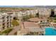 Aerial view of a community clubhouse, pool and condos with desert landscaping and mountain views at 5350 E Deer Valley Dr # 1253, Phoenix, AZ 85054