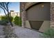 View of the exterior of a stone building with landscaping and decorative rock in front at 5350 E Deer Valley Dr # 1253, Phoenix, AZ 85054