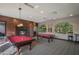 Spacious game room featuring pool tables, fireplace, ample lighting, and stylish decor at 5350 E Deer Valley Dr # 1253, Phoenix, AZ 85054