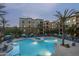 A tranquil pool with blue umbrellas, surrounded by manicured landscaping and upscale building at 5350 E Deer Valley Dr # 1253, Phoenix, AZ 85054