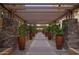 A covered walkway with stone columns and potted plants, offering a shaded and visually appealing path at 5350 E Deer Valley Dr # 1253, Phoenix, AZ 85054