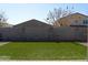 Backyard featuring gravel, grass, a block wall, landscaping and neighboring rooftops at 625 W Panola Dr, San Tan Valley, AZ 85140