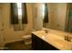 Bright bathroom featuring a double sink vanity with bronze faucets, a decorative mirror and modern fixtures at 625 W Panola Dr, San Tan Valley, AZ 85140