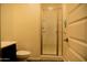 Neutral bathroom featuring a glass-doored shower, toilet and sink with a solid door at 625 W Panola Dr, San Tan Valley, AZ 85140