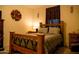 Comfortable bedroom with rustic wood bed frame at 625 W Panola Dr, San Tan Valley, AZ 85140