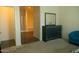 Bright bedroom with a gray dresser, mirror and comfortable blue chair at 625 W Panola Dr, San Tan Valley, AZ 85140