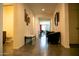 Bright hallway with tile flooring, stylish furniture, and decor leading to the living spaces at 625 W Panola Dr, San Tan Valley, AZ 85140