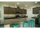 Close up of Kitchen island with granite countertops, seating, pendant lighting, and stainless steel appliances at 625 W Panola Dr, San Tan Valley, AZ 85140