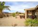 Expansive backyard featuring a covered patio with seating, lush landscaping, and a serene ambiance at 6390 S Granite Dr, Chandler, AZ 85249