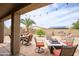 Backyard oasis with a fire pit, covered patio, and lush greenery, perfect for outdoor relaxation and entertainment at 6390 S Granite Dr, Chandler, AZ 85249