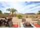 Backyard with covered patio, fire pit, seating, and desert landscaping at 6390 S Granite Dr, Chandler, AZ 85249