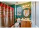 Colorful bathroom featuring a vanity sink, toilet, and patterned shower curtain for a vibrant aesthetic at 6390 S Granite Dr, Chandler, AZ 85249