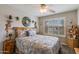 A cozy bedroom featuring neutral tones, a ceiling fan, and a window with shutters for natural light at 6390 S Granite Dr, Chandler, AZ 85249